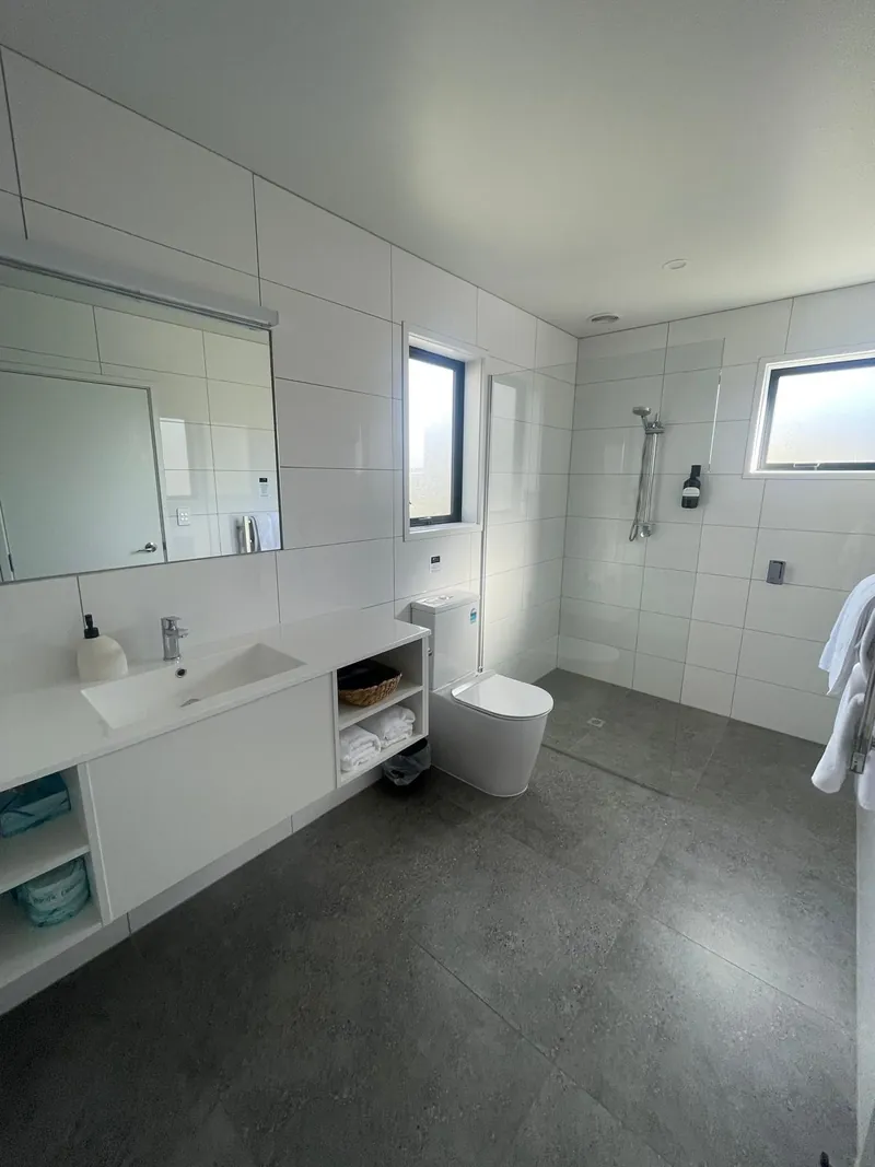 Modern bathroom with walk-in shower and vanity, Kerigold Chalets Kerikeri