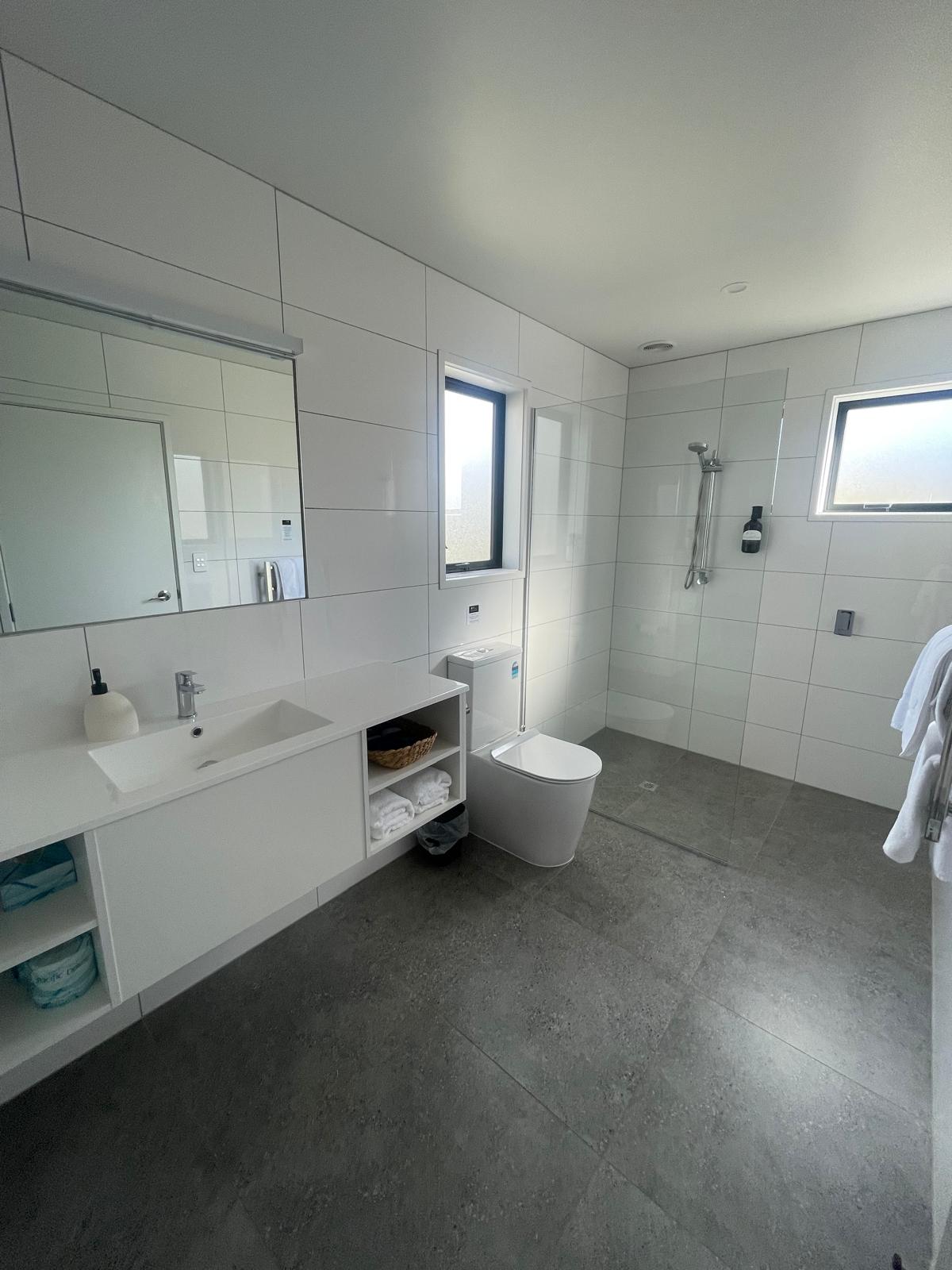 Modern bathroom with walk-in shower and vanity, Kerigold Chalets Kerikeri