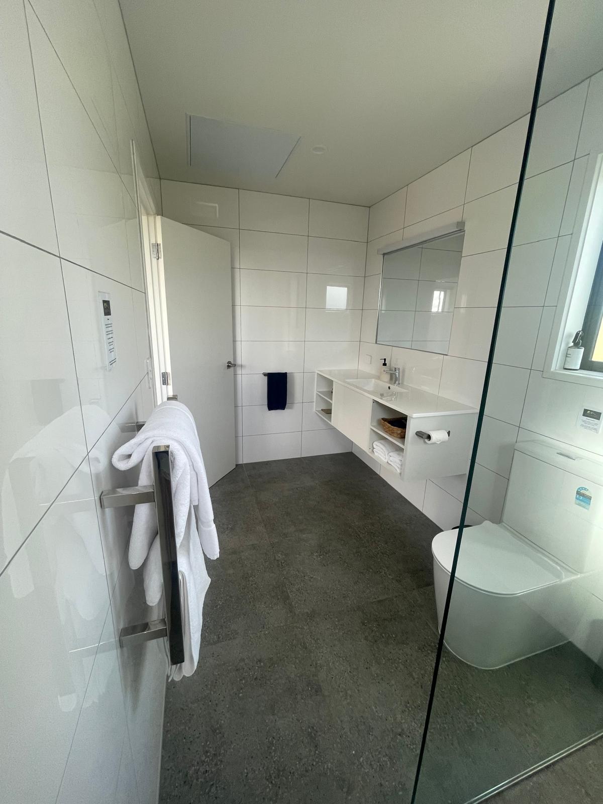 Fully tiled bathroom with heated towel rail in executive studio, Kerigold Chalets Kerikeri