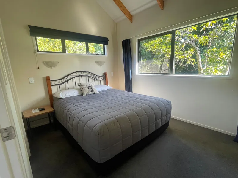 Separate bedroom with queen bed and orchard views, Boutique Chalet