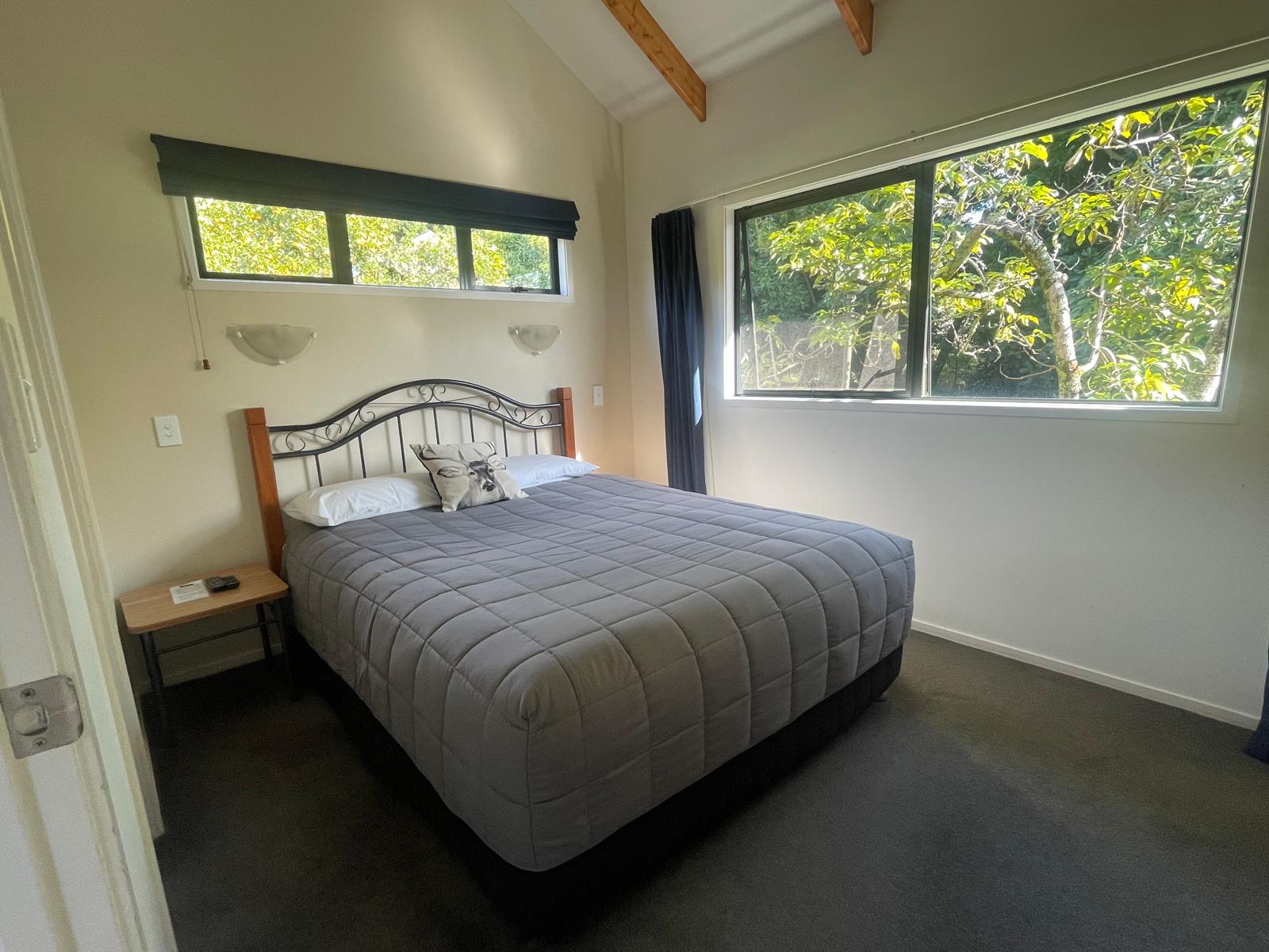 Separate bedroom with queen bed and orchard views, Boutique Chalet
