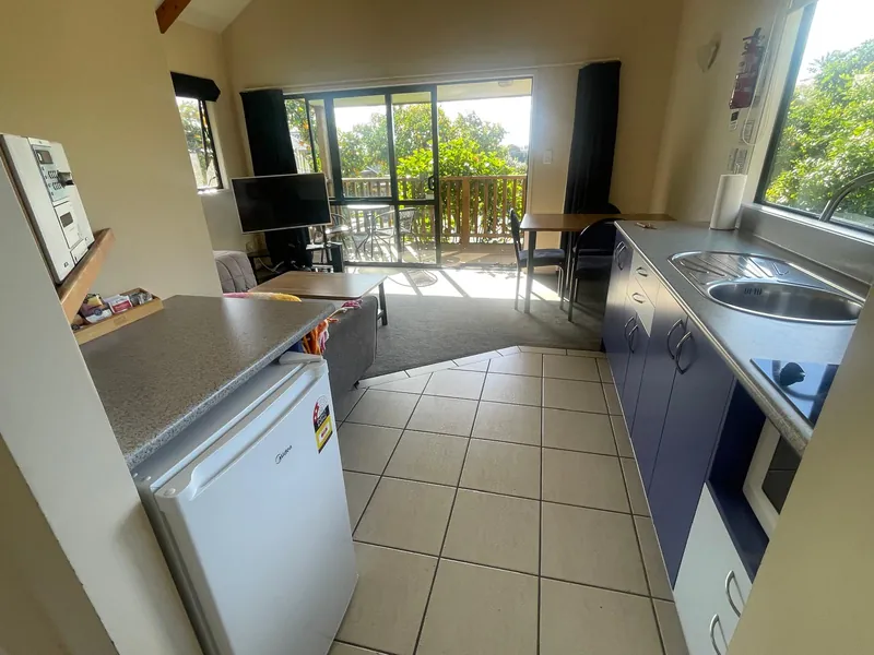 Kitchen and living area with deck views, Boutique Chalet Kerikeri